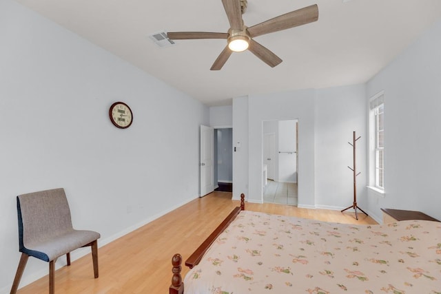 10020 Lachlan Dr, Austin, TX 78717 - bedroom with visible vents, baseboards, wood finished floors, ceiling fan, and connected bathroom