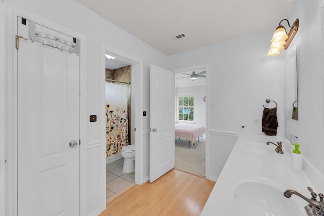 10020 Lachlan Dr, Austin, TX 78717 - ensuite bathroom featuring a sink, double vanity, toilet, ensuite bathroom, and wood finished floors