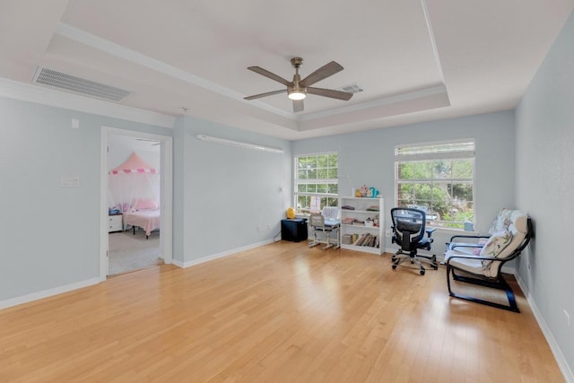 10020 Lachlan Dr, Austin, TX 78717 - living area featuring a tray ceiling, wood finished floors, visible vents, and a ceiling fan