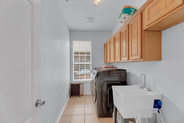10020 Lachlan Dr, Austin, TX 78717 - washroom featuring a sink, light tile patterned floors, baseboards, washer and dryer, and cabinet space