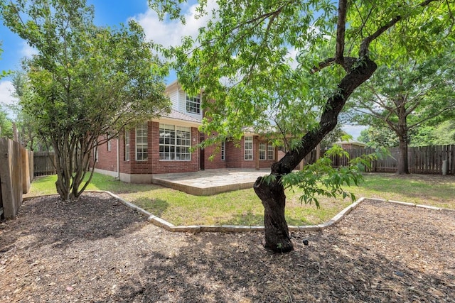 10020 Lachlan Dr, Austin, TX 78717 - back of property featuring a lawn, a fenced backyard, brick siding, and a patio
