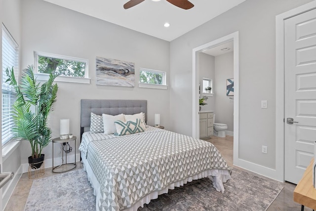 bedroom featuring multiple windows, baseboards, ensuite bathroom, recessed lighting, and ceiling fan