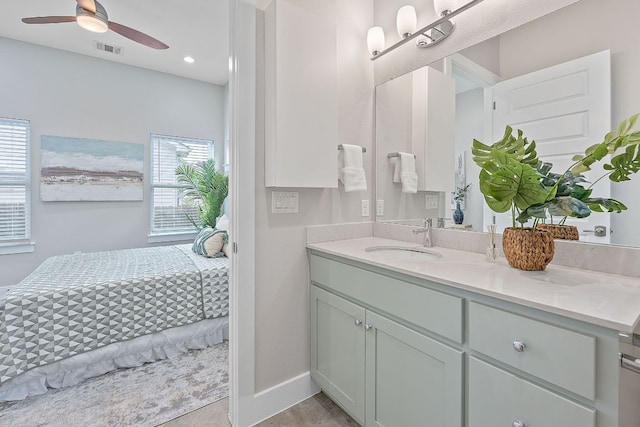 bathroom with vanity, ceiling fan, baseboards, and recessed lighting