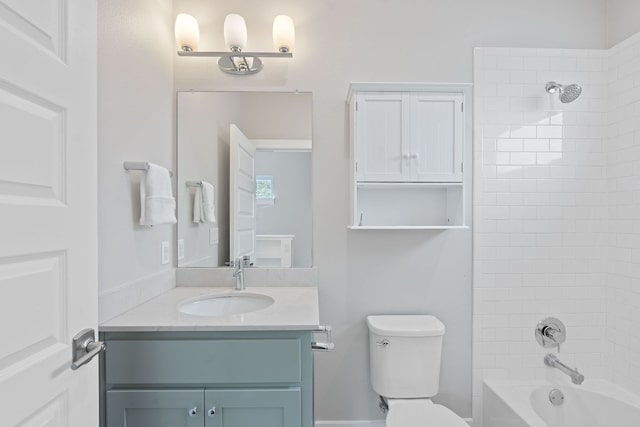 bathroom featuring toilet, vanity, and washtub / shower combination