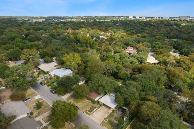 drone / aerial view featuring a wooded view