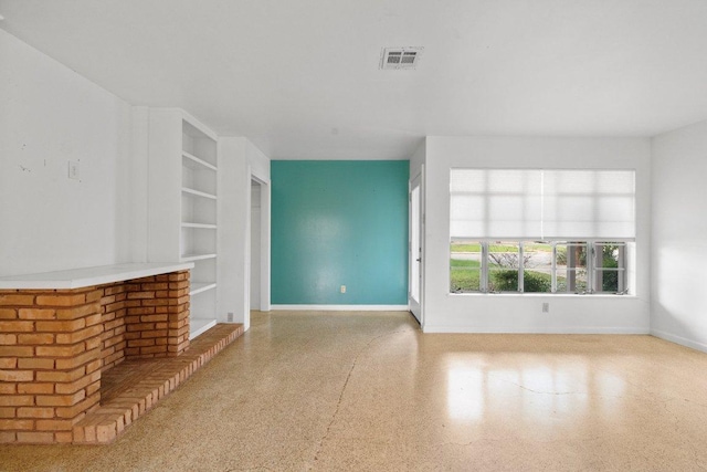 unfurnished living room featuring speckled floor, visible vents, and baseboards