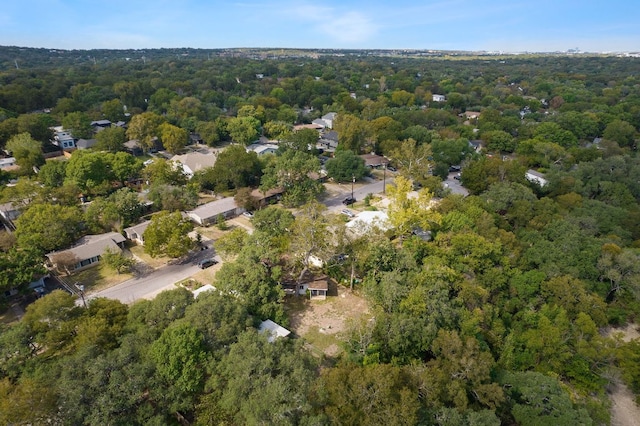 birds eye view of property with a view of trees