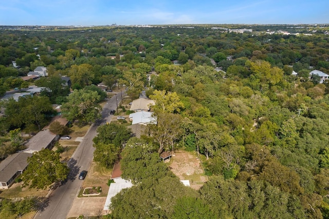 bird's eye view with a wooded view