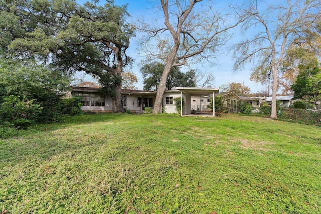 view of yard featuring a carport and fence