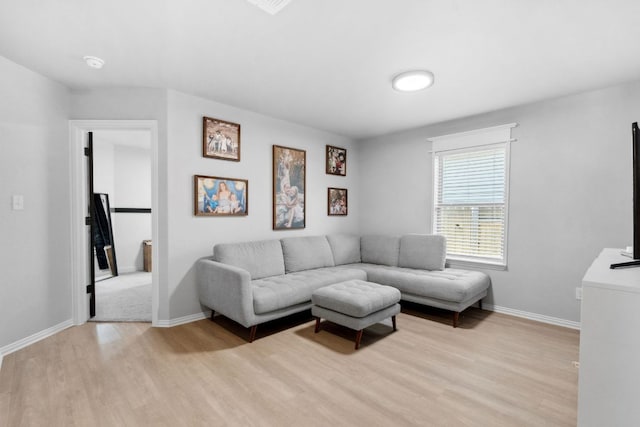 living room featuring light wood-style floors and baseboards