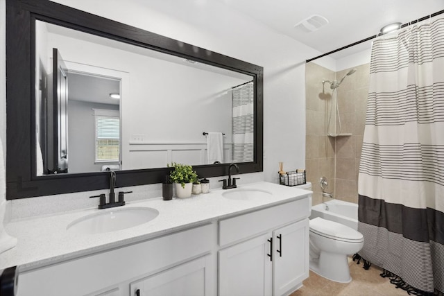full bath with shower / bath combination with curtain, double vanity, toilet, and a sink