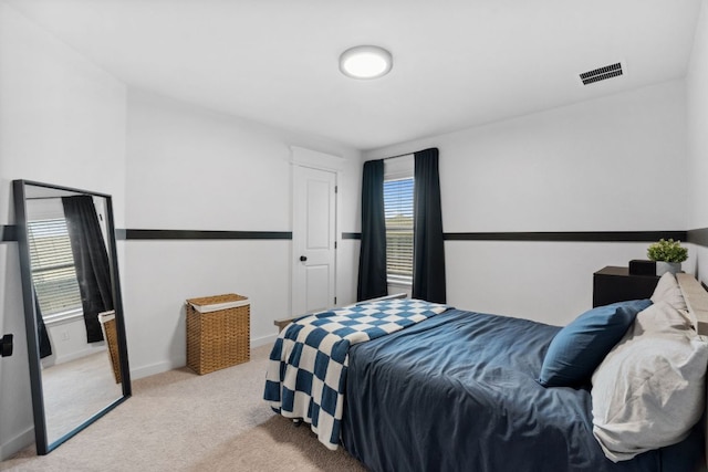 bedroom featuring light carpet, baseboards, and visible vents