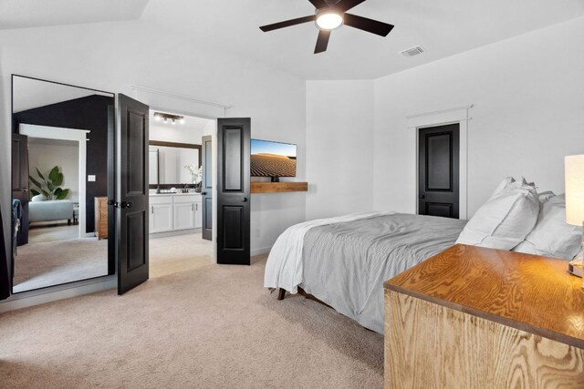 bedroom featuring ceiling fan, visible vents, light carpet, and connected bathroom