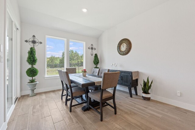 dining room featuring light wood-type flooring, baseboards, and recessed lighting