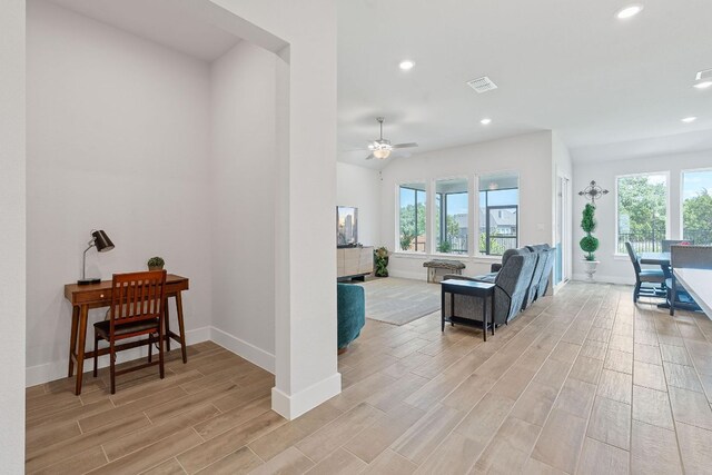 living area with visible vents, recessed lighting, light wood-style floors, and a healthy amount of sunlight