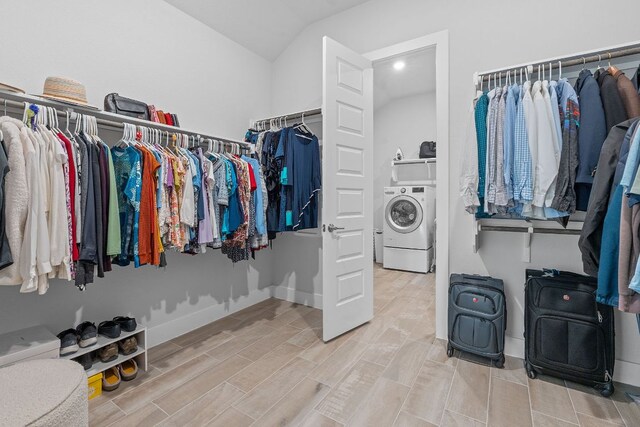 walk in closet with lofted ceiling, washer / clothes dryer, and wood finished floors