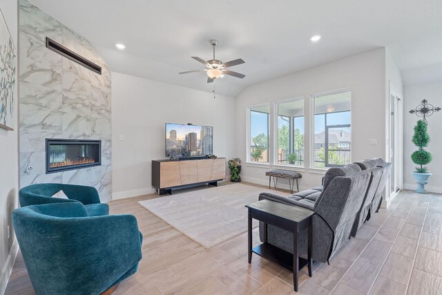 living room featuring recessed lighting, wood tiled floor, a premium fireplace, baseboards, and ceiling fan