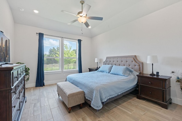bedroom featuring a ceiling fan, baseboards, and wood tiled floor