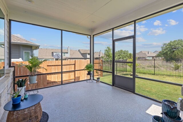 sunroom / solarium featuring a residential view