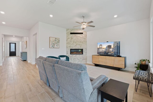 living room with recessed lighting, a ceiling fan, visible vents, and light wood-type flooring