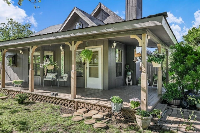 rear view of house with a porch and metal roof