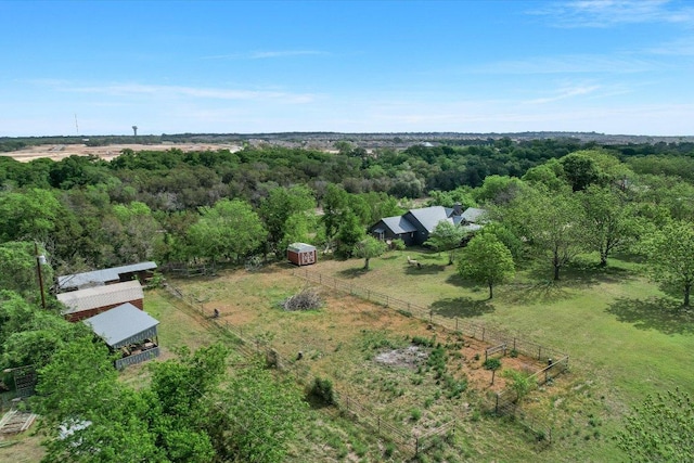 birds eye view of property featuring a rural view and a view of trees