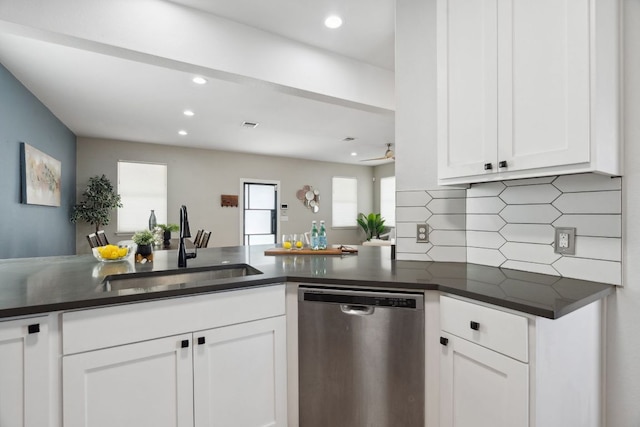 7617 Carver Ave Unit 1, Austin, TX 78752 - kitchen featuring stainless steel dishwasher, a sink, dark countertops, white cabinetry, and tasteful backsplash