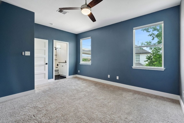 7617 Carver Ave Unit 1, Austin, TX 78752 - unfurnished bedroom featuring multiple windows, carpet floors, and baseboards