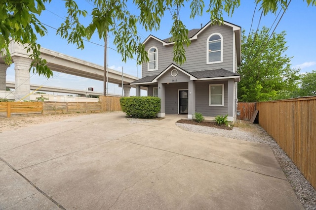 7617 Carver Ave Unit 1, Austin, TX 78752 - traditional-style home featuring roof with shingles and covered porch