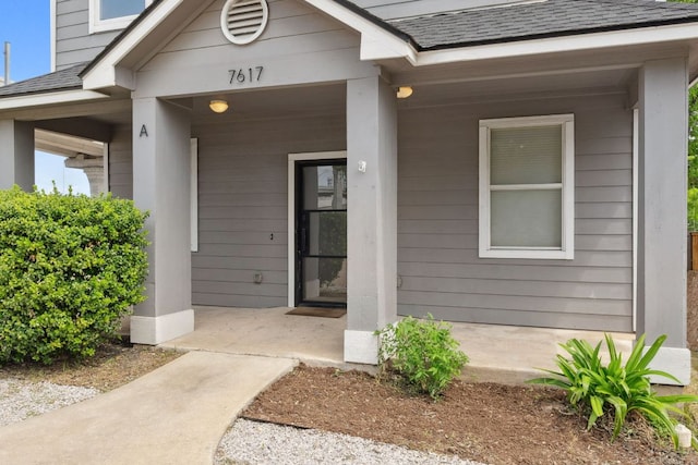 7617 Carver Ave Unit 1, Austin, TX 78752 - property entrance featuring a shingled roof and covered porch