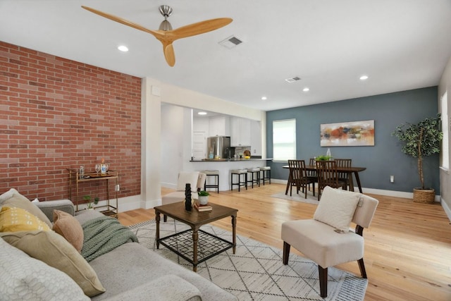 7617 Carver Ave Unit 1, Austin, TX 78752 - living room with light wood-style floors, baseboards, brick wall, recessed lighting, and ceiling fan