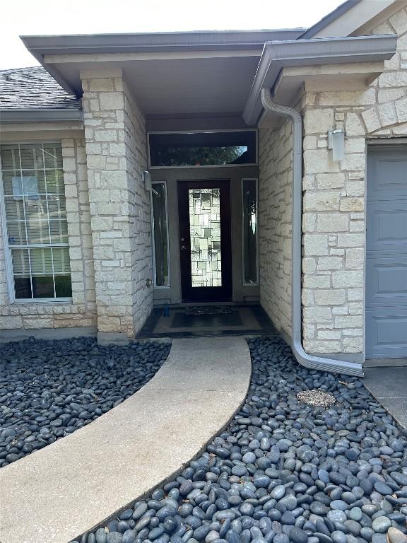 doorway to property with stone siding