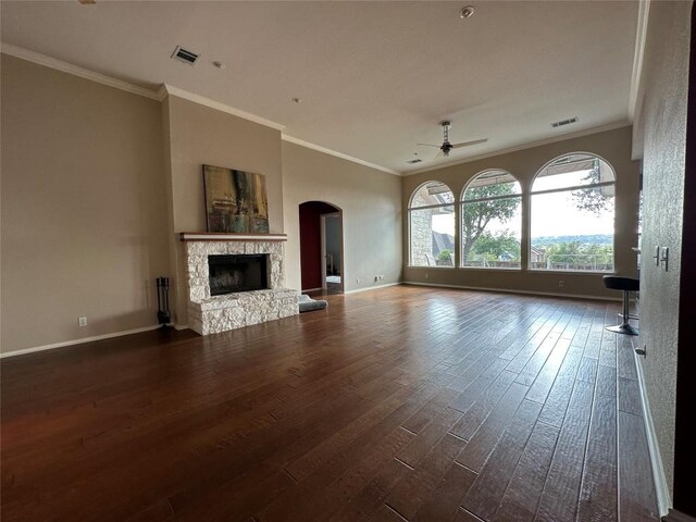 unfurnished living room with ceiling fan, baseboards, dark wood-style flooring, and a stone fireplace