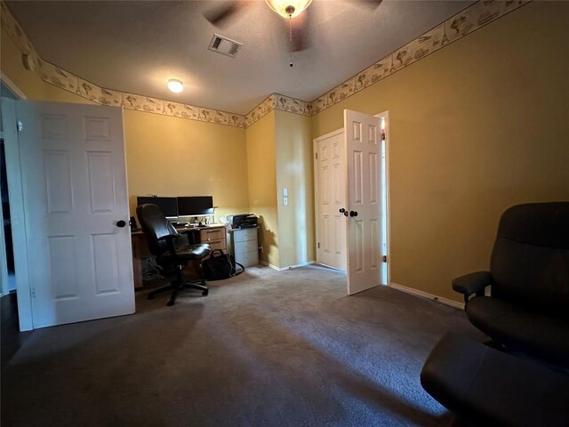 home office with baseboards, a ceiling fan, visible vents, and carpet