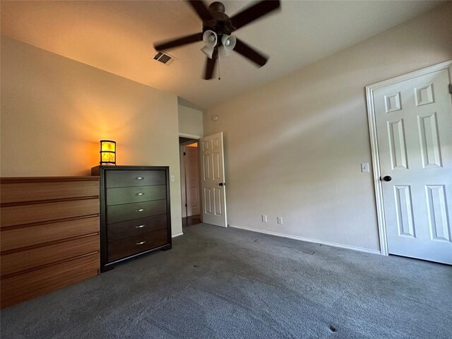 unfurnished bedroom with baseboards, a ceiling fan, dark colored carpet, and visible vents