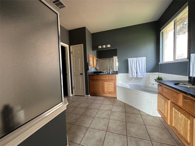 bathroom featuring a shower stall, tile patterned floors, a sink, a bath, and visible vents