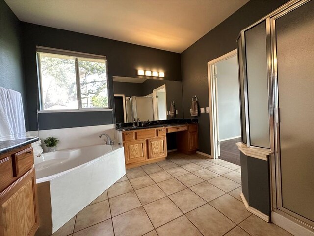bathroom featuring a garden tub, vanity, tile patterned flooring, and a shower stall