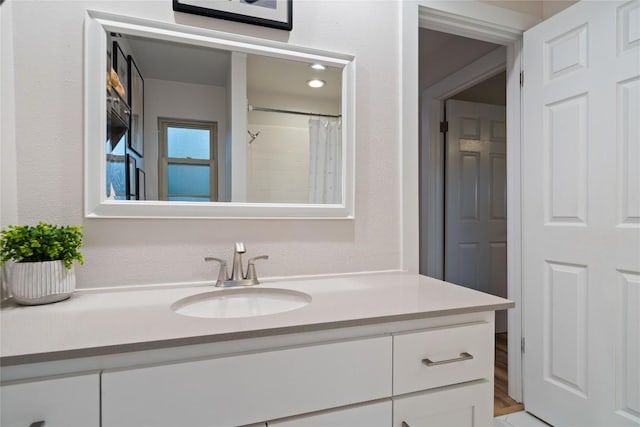 full bath with a shower with curtain and vanity