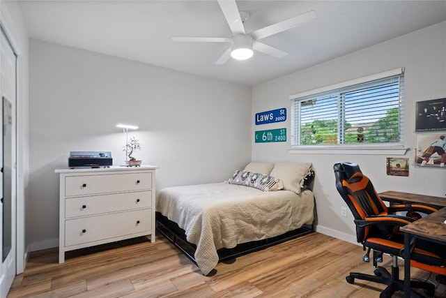 bedroom featuring light wood-style floors, ceiling fan, and baseboards