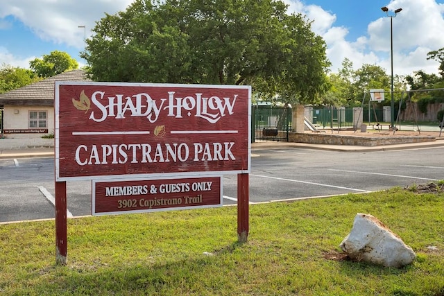 exterior details with a parking lot and fence