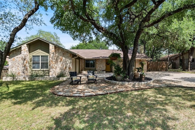 11311 Aloysia Dr, Austin, TX 78748 - back of house with stone siding, a patio area, and concrete driveway