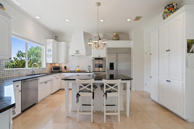 4014 Walnut Clay Dr, Austin, TX 78731 - kitchen featuring stainless steel appliances, decorative backsplash, a chandelier, custom range hood, and white cabinets