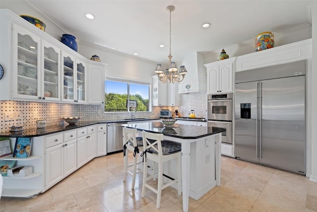 4014 Walnut Clay Dr, Austin, TX 78731 - kitchen with appliances with stainless steel finishes, white cabinets, tasteful backsplash, glass insert cabinets, and ornamental molding