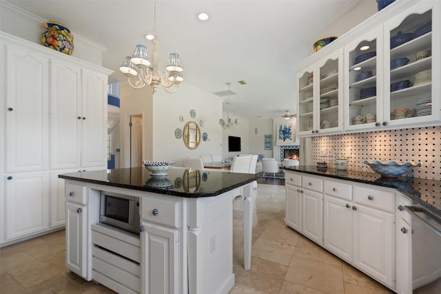 4014 Walnut Clay Dr, Austin, TX 78731 - kitchen with appliances with stainless steel finishes, white cabinetry, glass insert cabinets, a chandelier, and decorative light fixtures