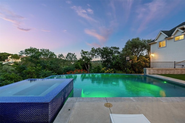4014 Walnut Clay Dr, Austin, TX 78731 - pool at dusk featuring a pool with connected hot tub