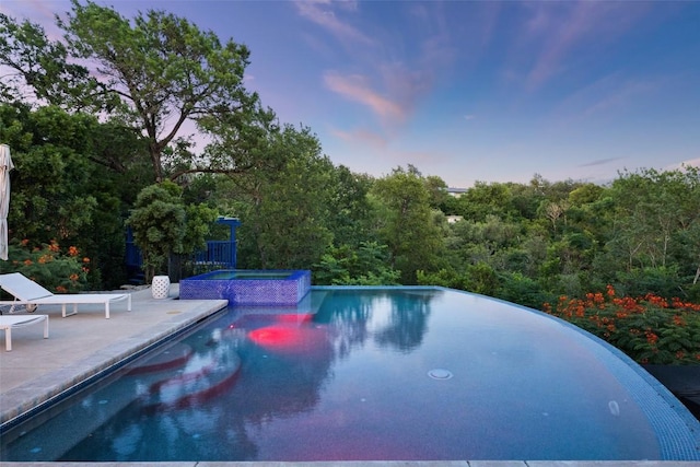 4014 Walnut Clay Dr, Austin, TX 78731 - pool at dusk with a patio and a pool with connected hot tub