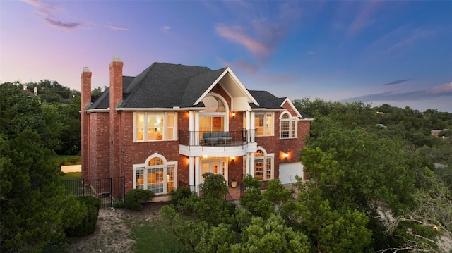 4014 Walnut Clay Dr, Austin, TX 78731 - colonial home with brick siding, a balcony, and a chimney