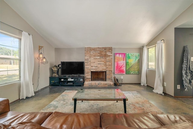 living room featuring lofted ceiling, a wealth of natural light, baseboards, and finished concrete floors