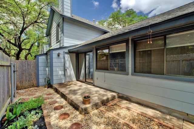 exterior space featuring a patio area, a chimney, and fence