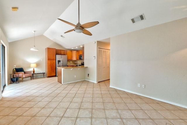 unfurnished living room featuring vaulted ceiling, visible vents, light tile patterned flooring, baseboards, and ceiling fan